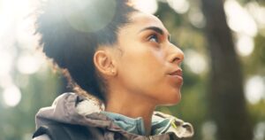 Woman looking into the distance while wondering whether a negative pregnancy test result could be false.