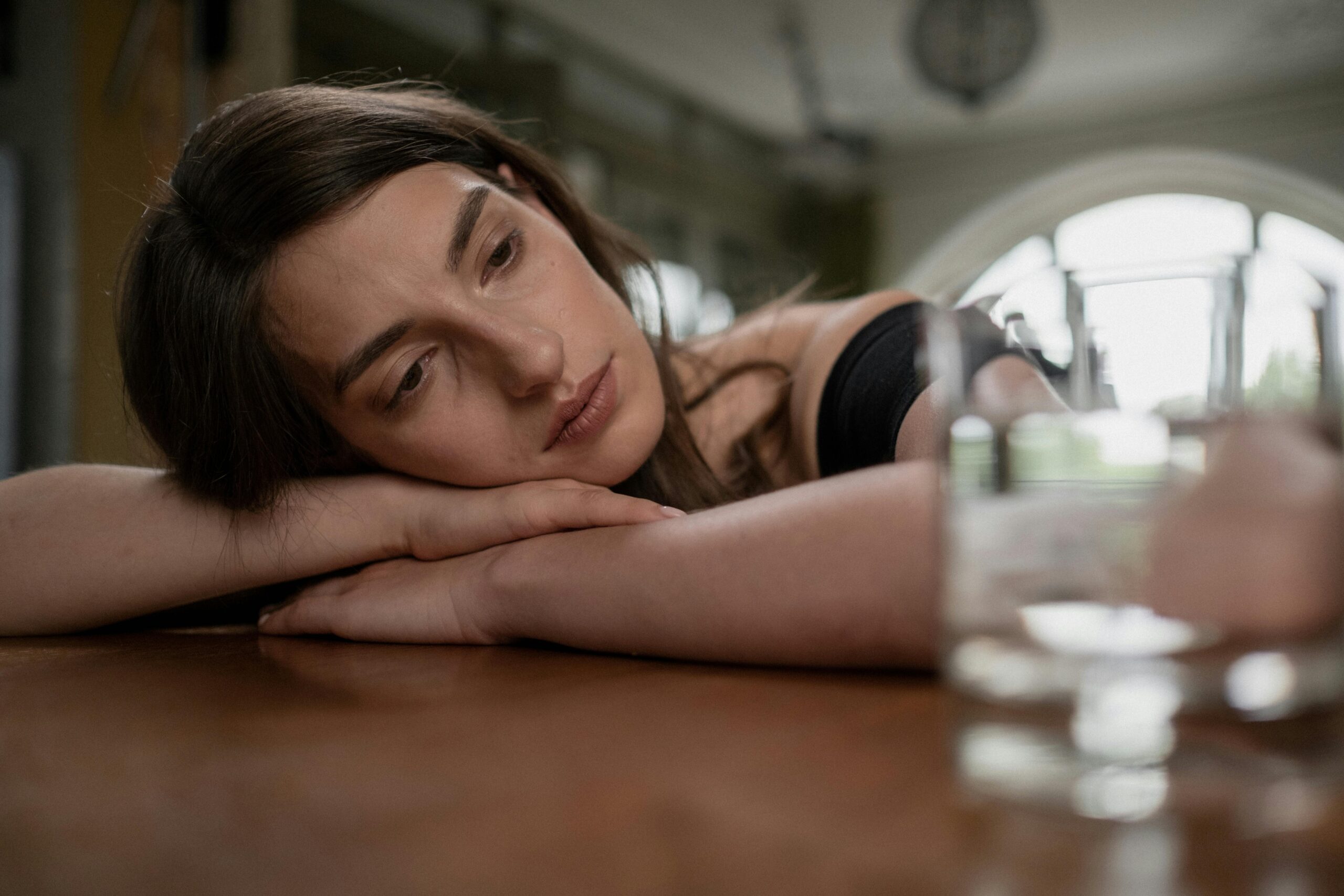 A woman considers how to discuss her pregnancy test results with her partner or a friend.